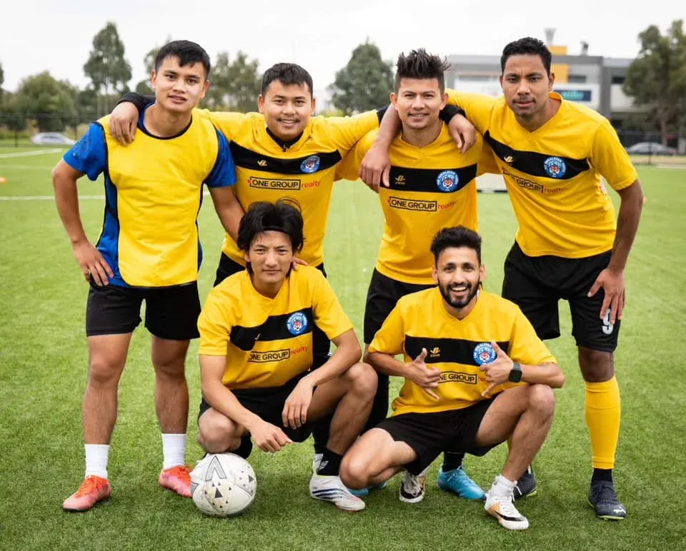 Players in yellow kits posing together