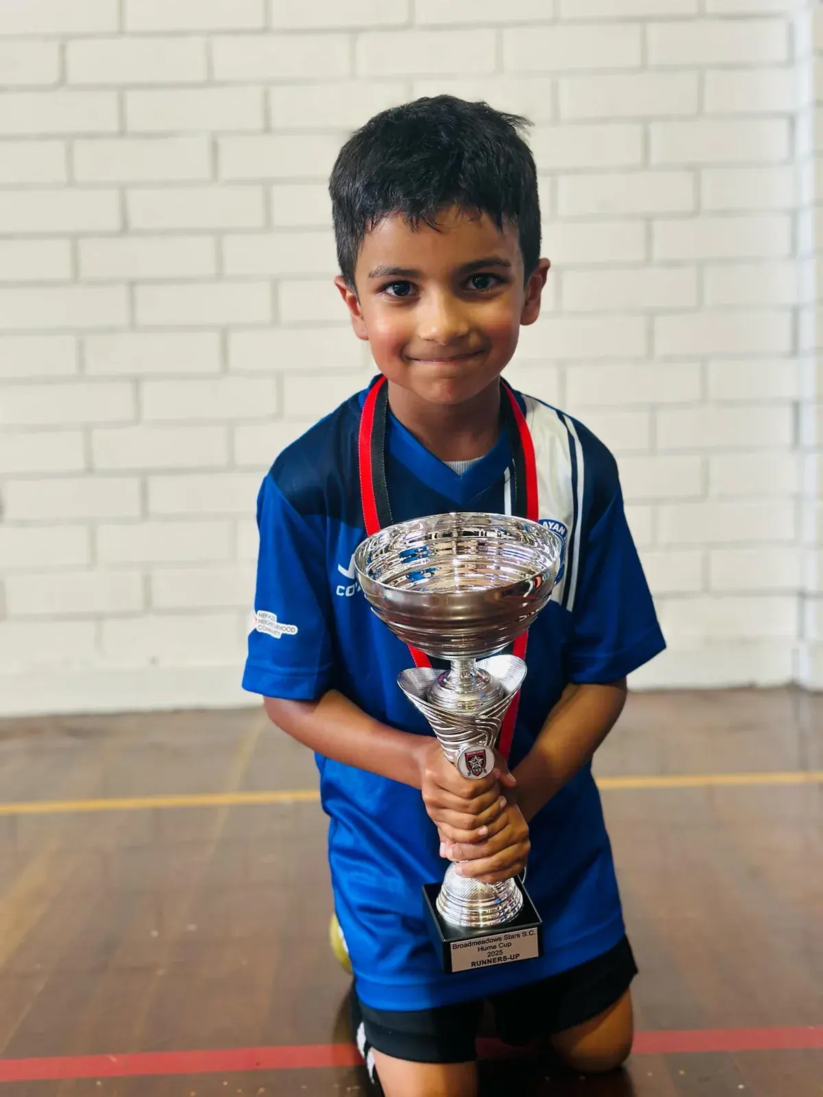 Young player holding a silver trophy