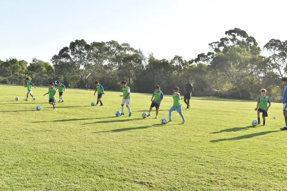 Academy players practising across the field