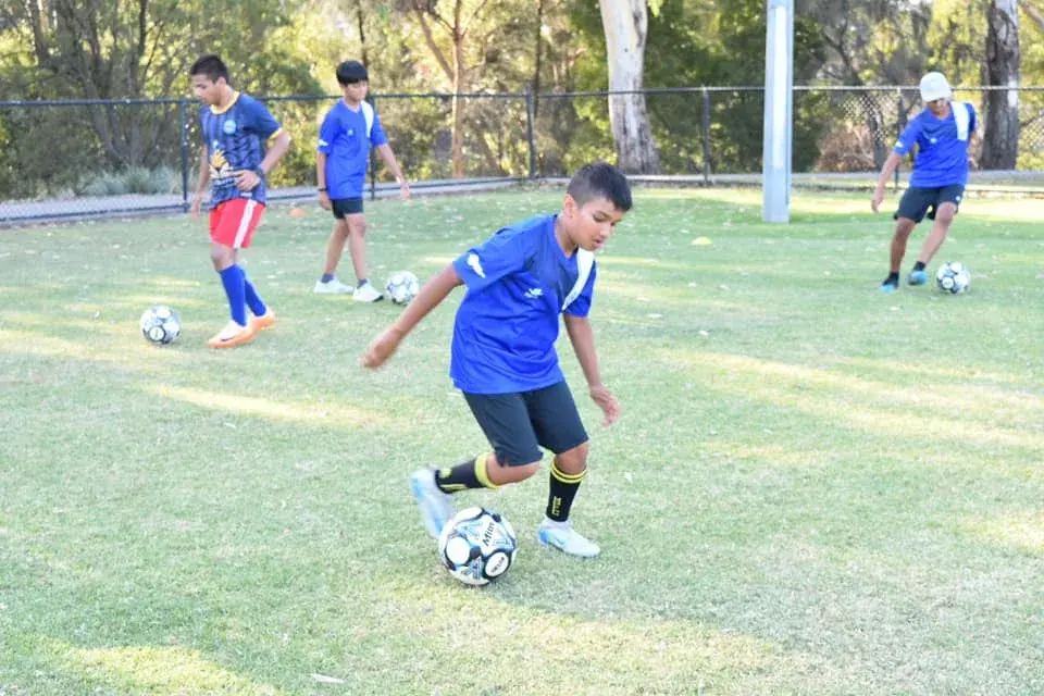 Young players practising dribbling