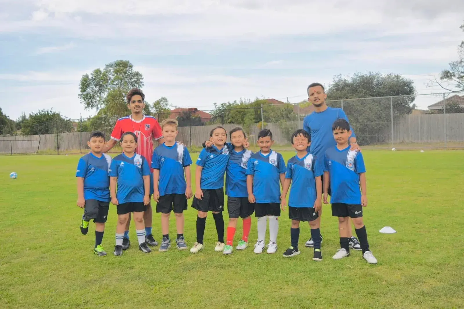 Academy team and coach posing together