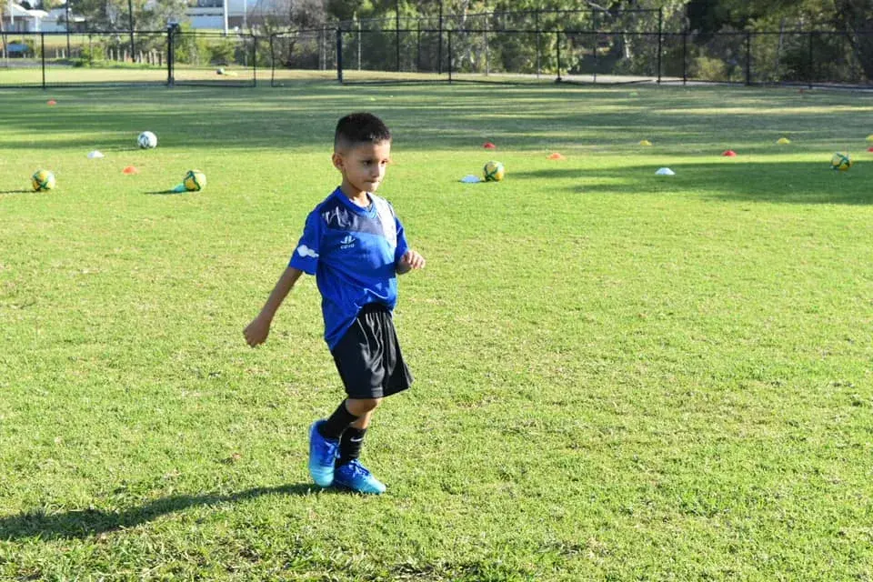 Young player running with the ball