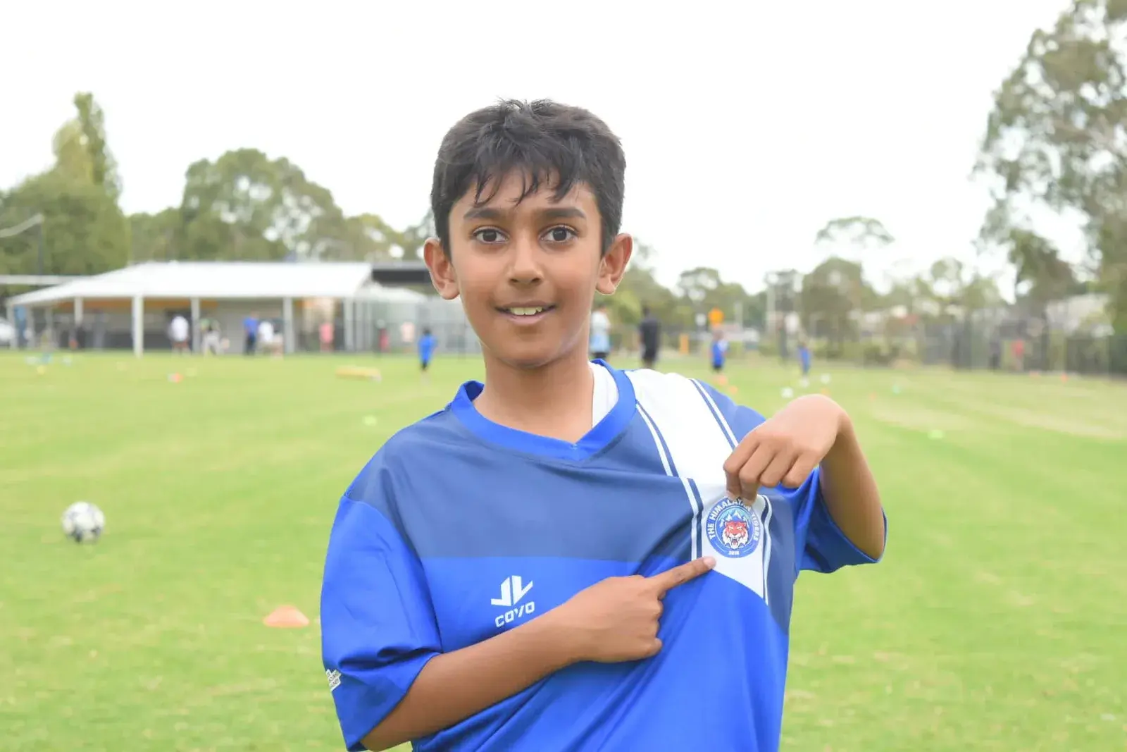 Young Tiger showing a medal