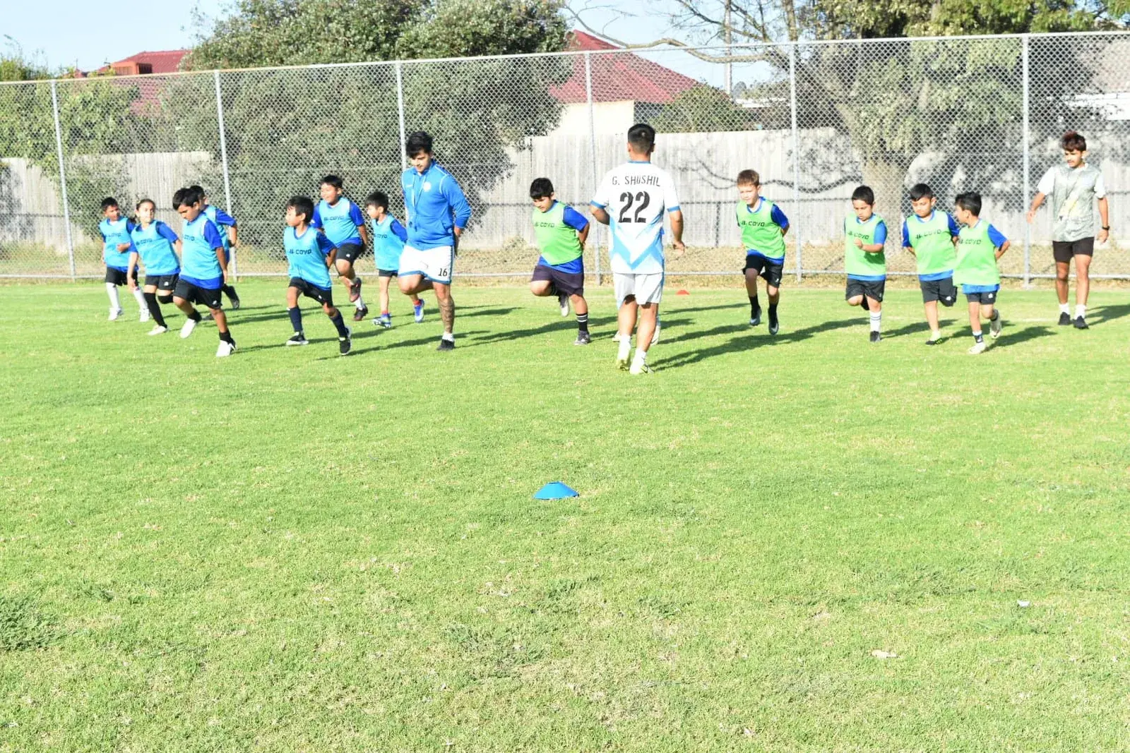 Children running across the training pitch