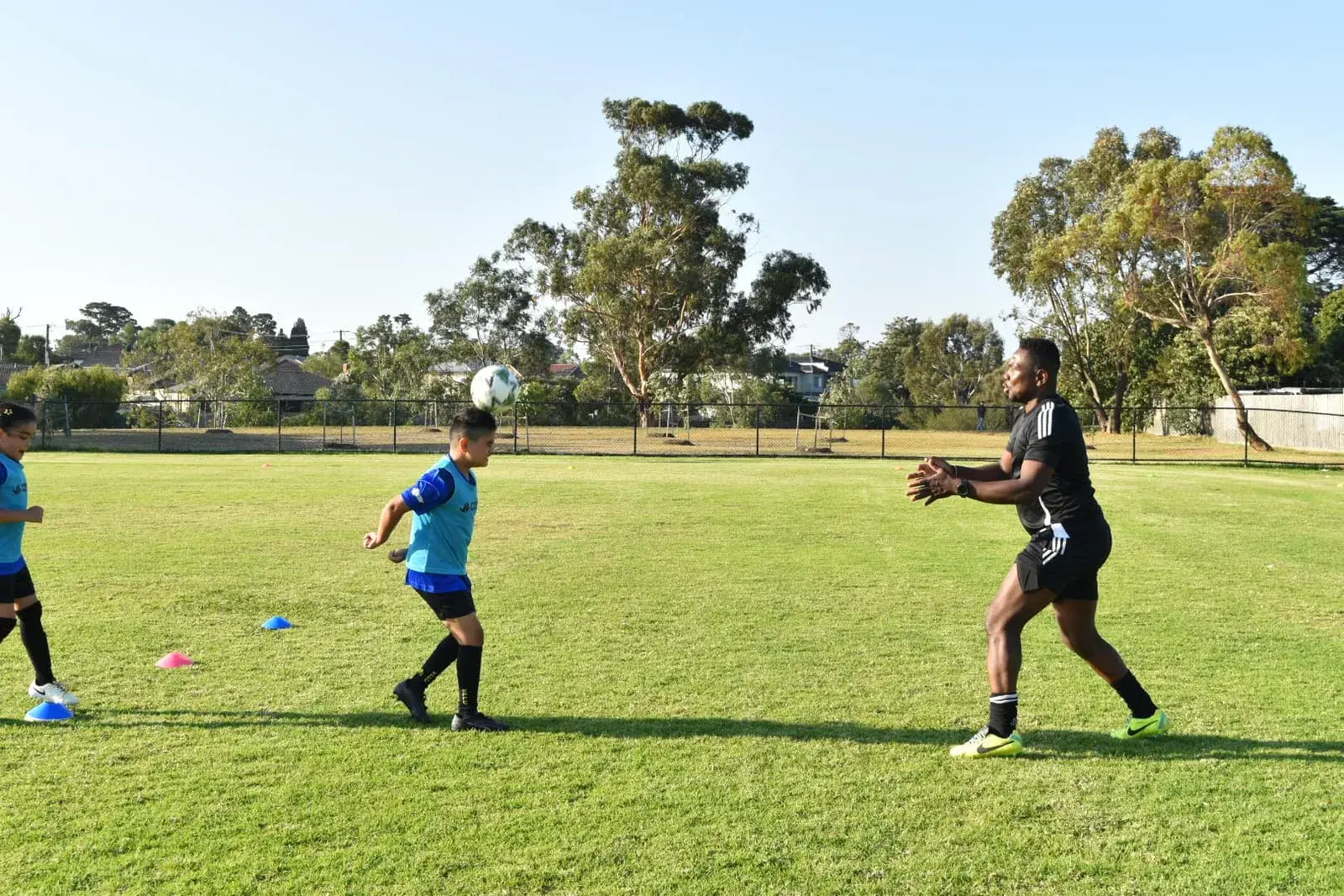 Coach demonstrating movement with a football