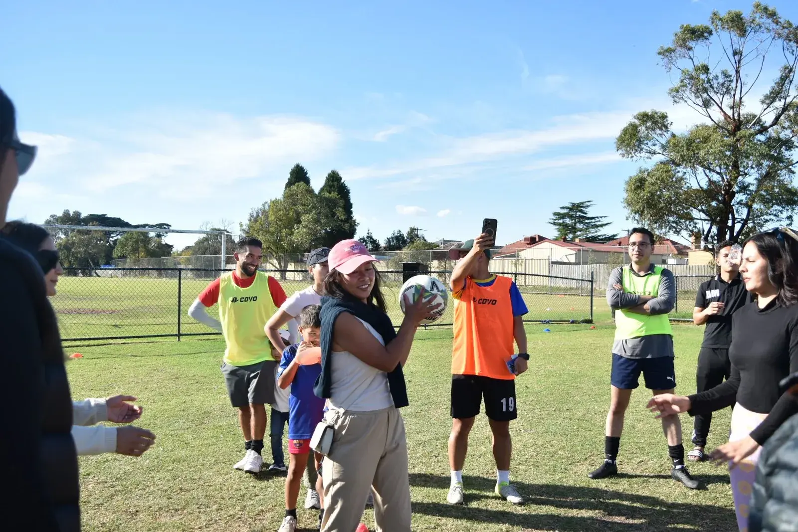 Participants gathered in a circle on the field