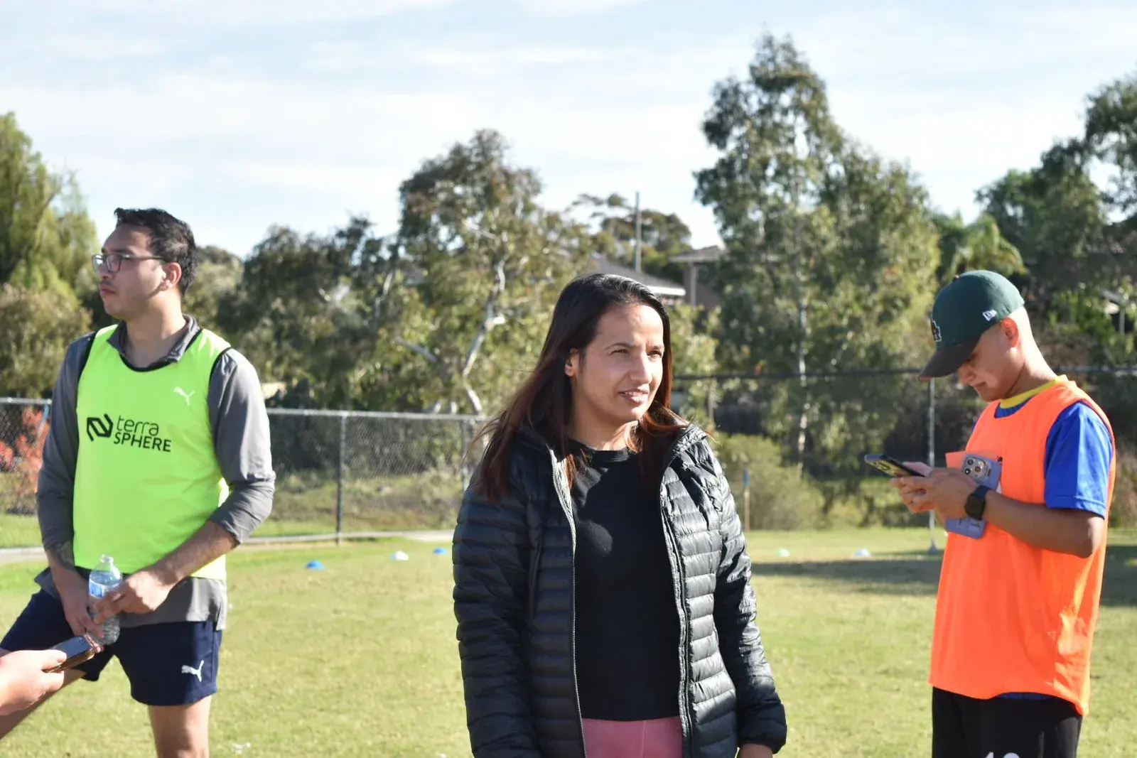 Two participants talking beside the field