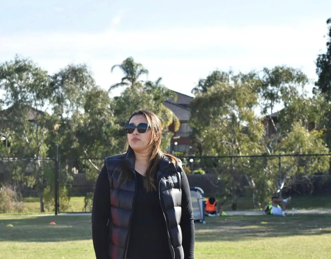Participant smiling beside the field