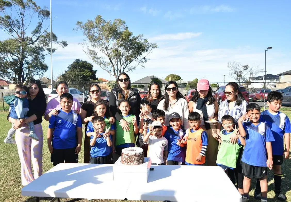 Families posing around the celebration table