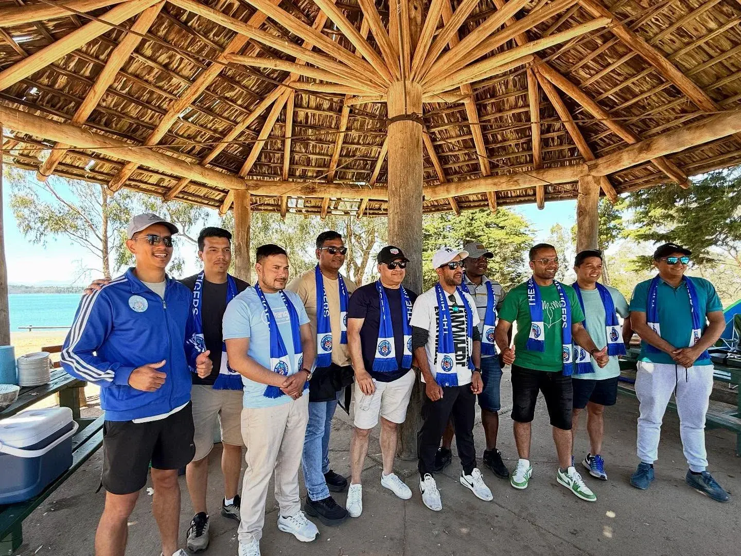 Club members posing together under a picnic shelter