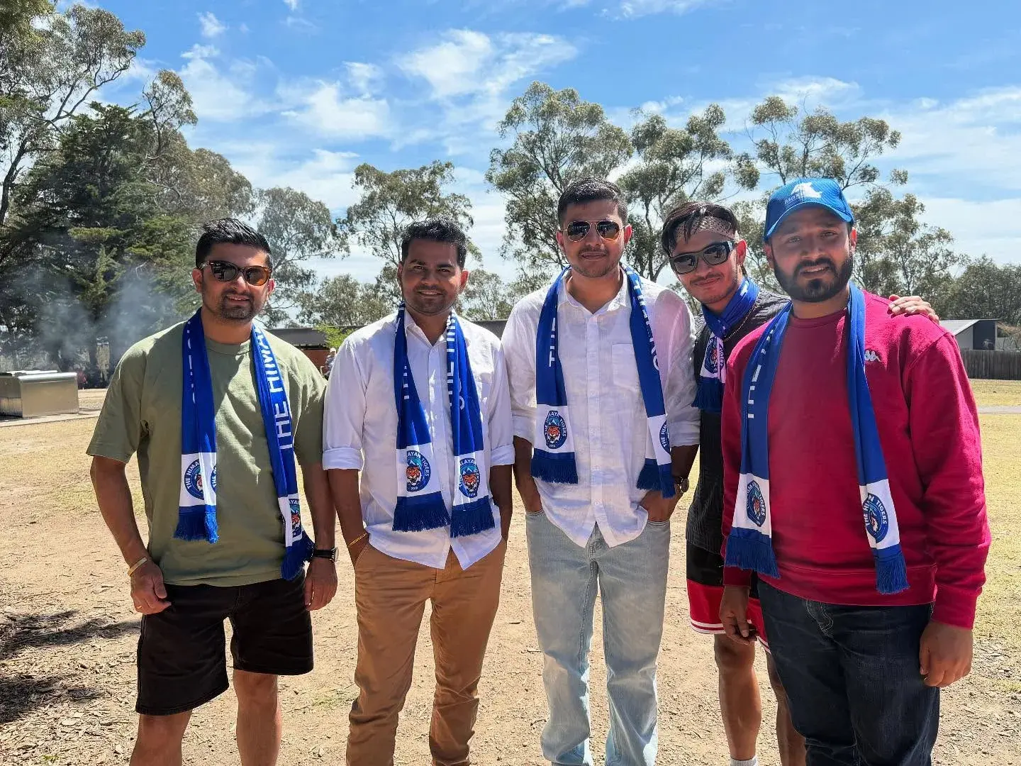 Four club members wearing scarves in the park