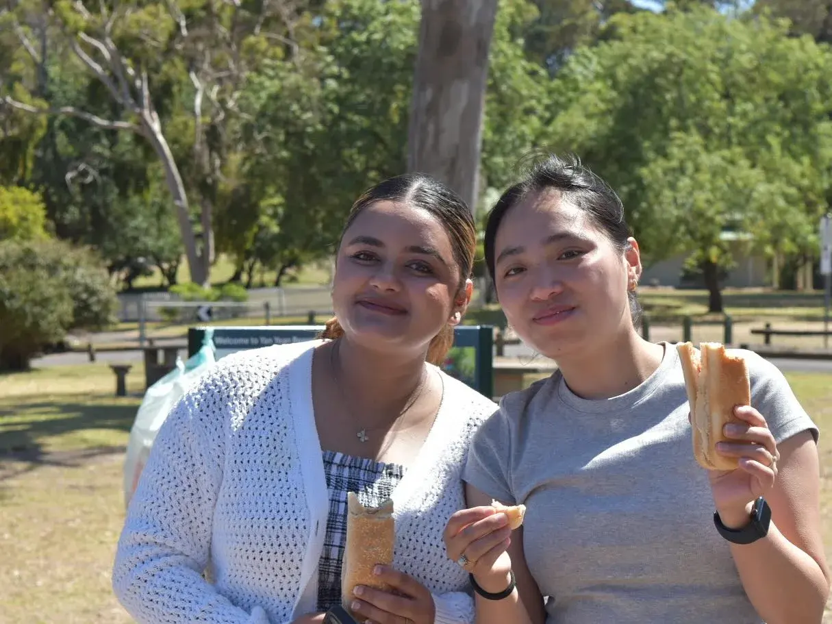 Two participants sharing food at the picnic