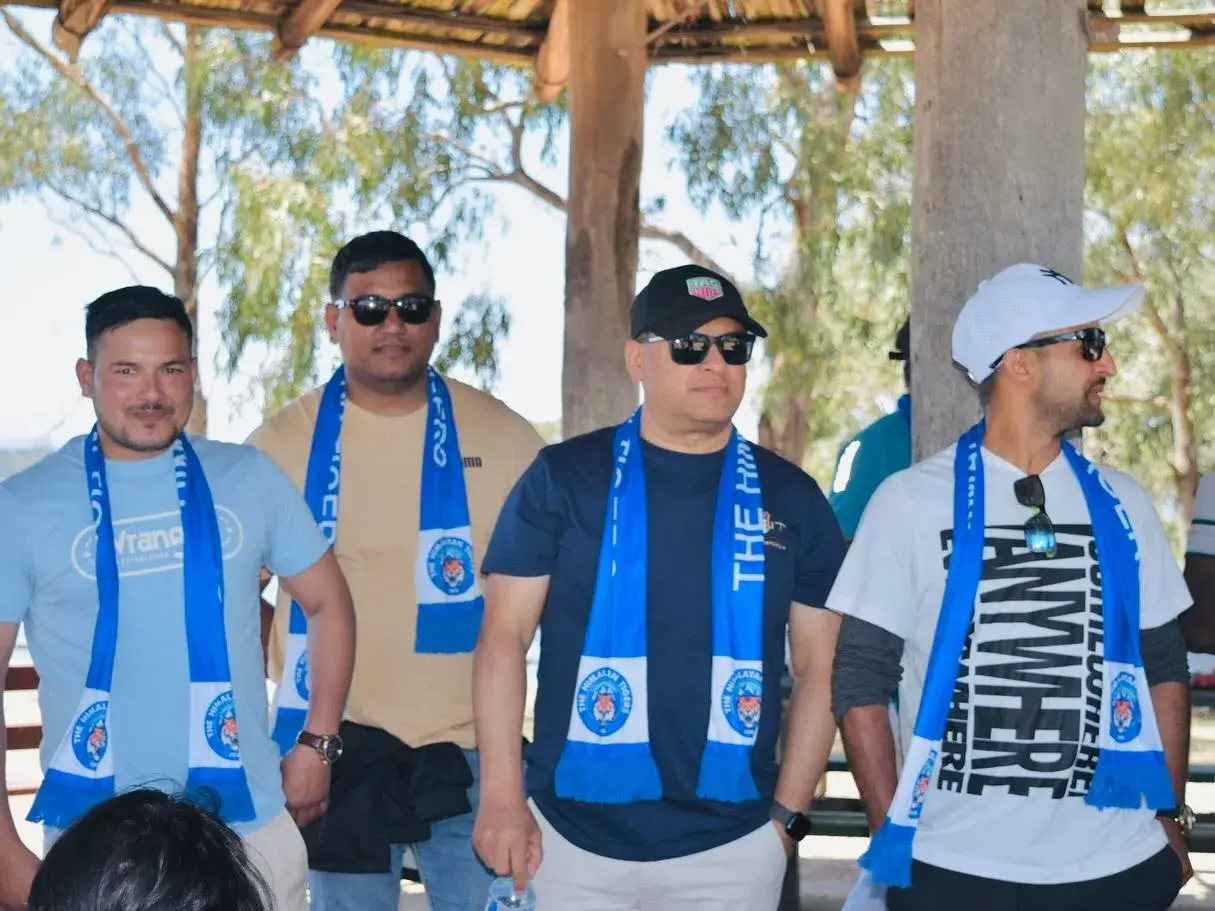 Club members wearing scarves under the shelter