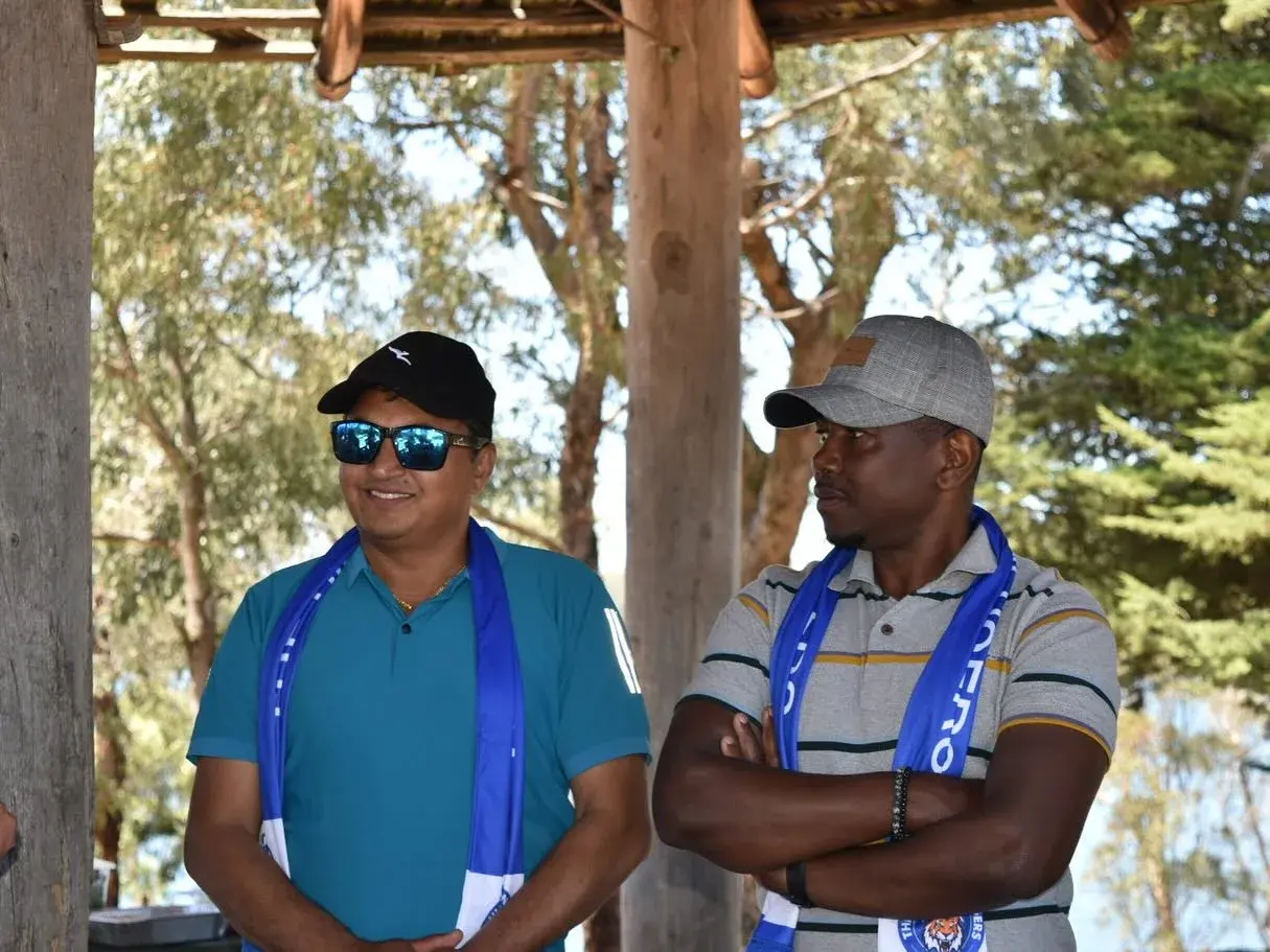 Two club members talking under the shelter