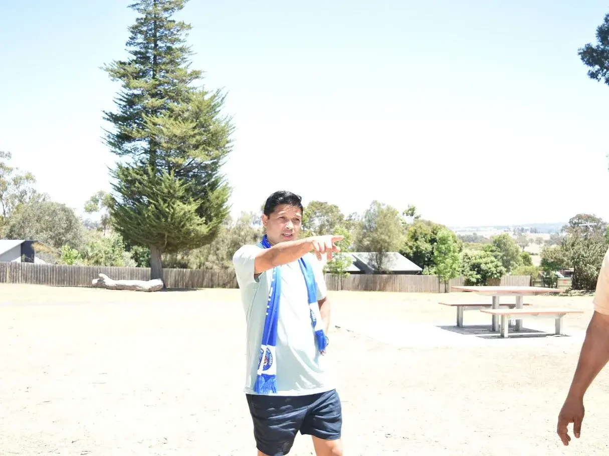 Club member standing beside the picnic tables