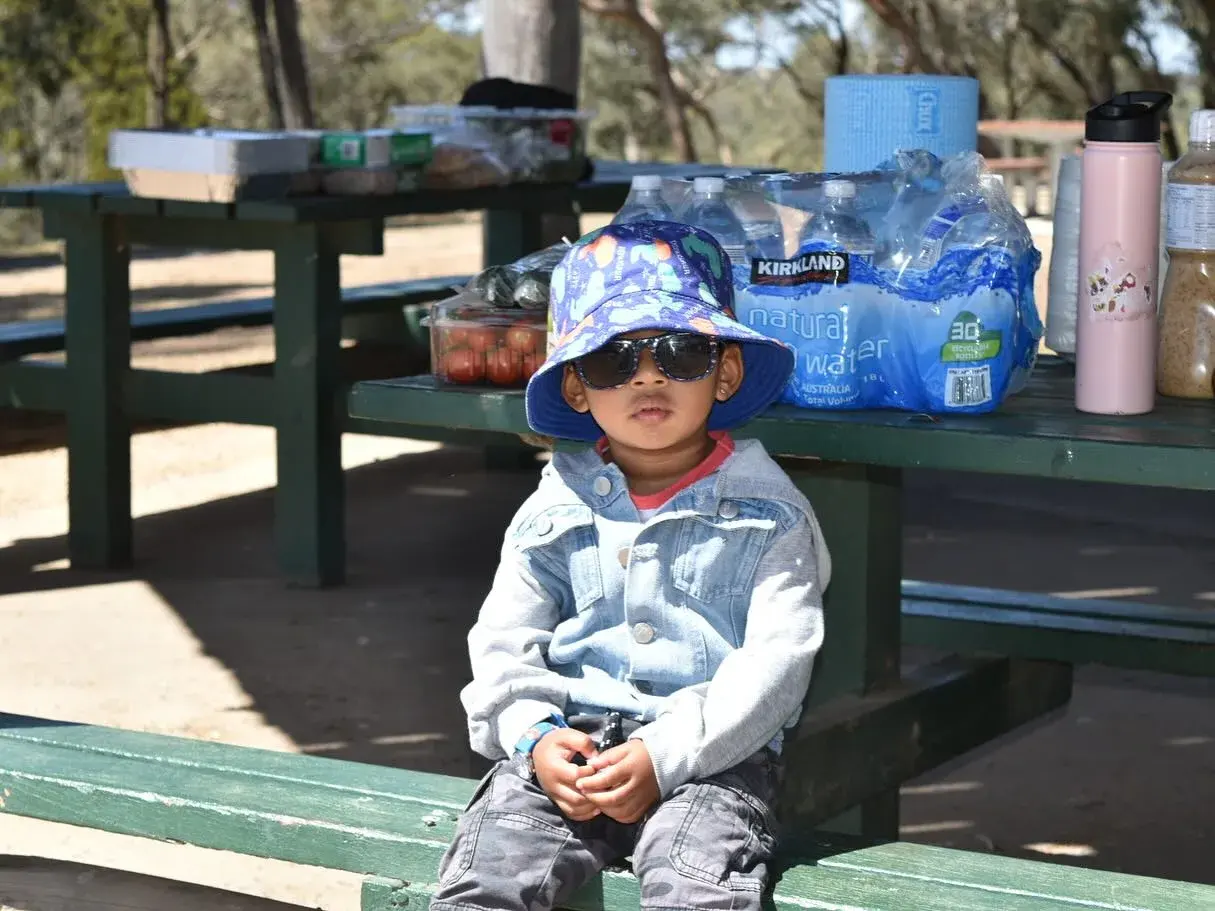 Child resting on a park bench