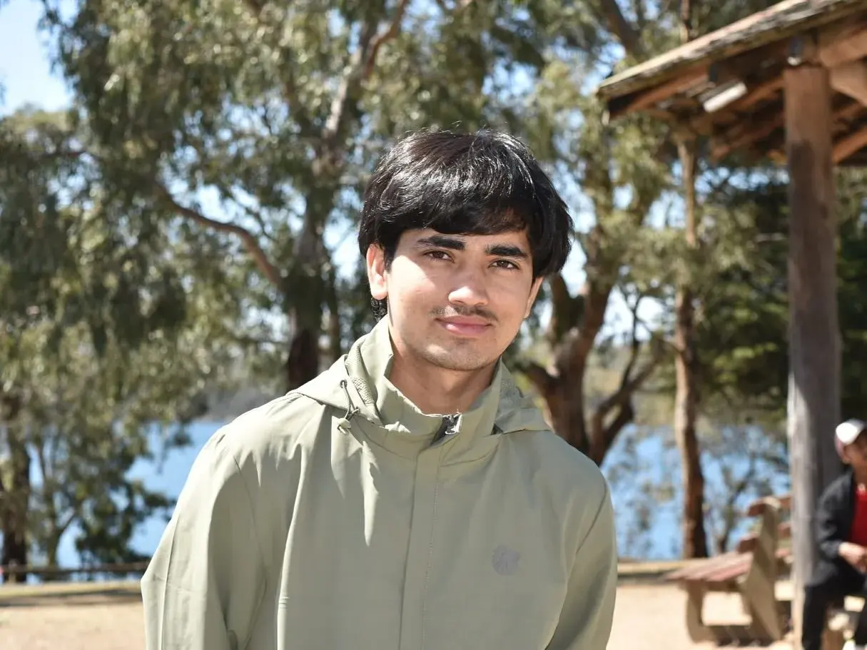Participant posing beside a tree