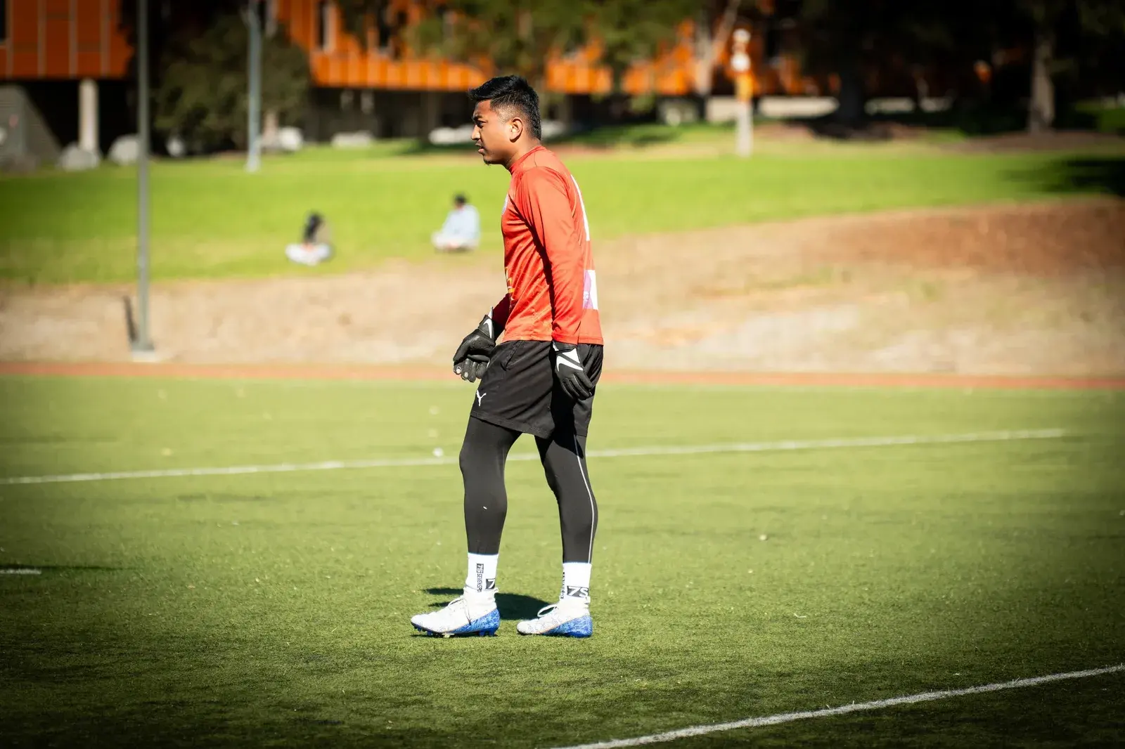 Goalkeeper standing with a football
