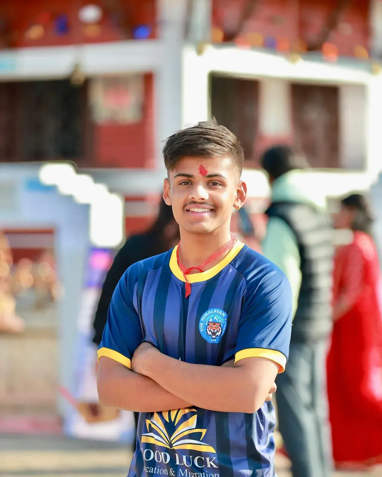Club member posing in a blue football shirt