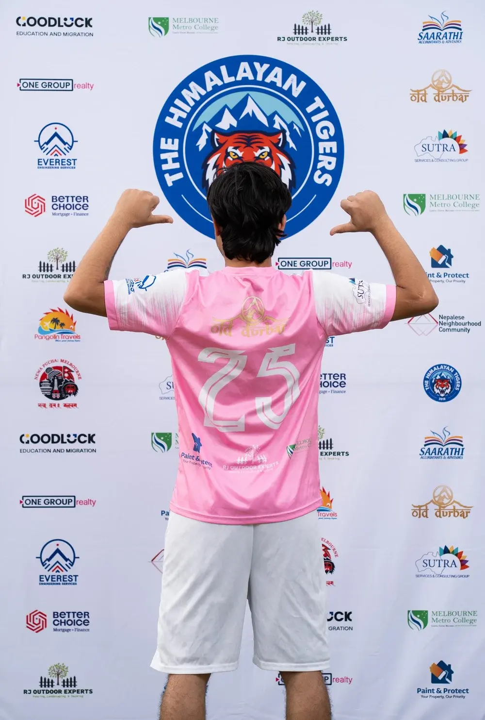 Player showing the back of the pink Tigers jersey, with white number 25 and sponsor details