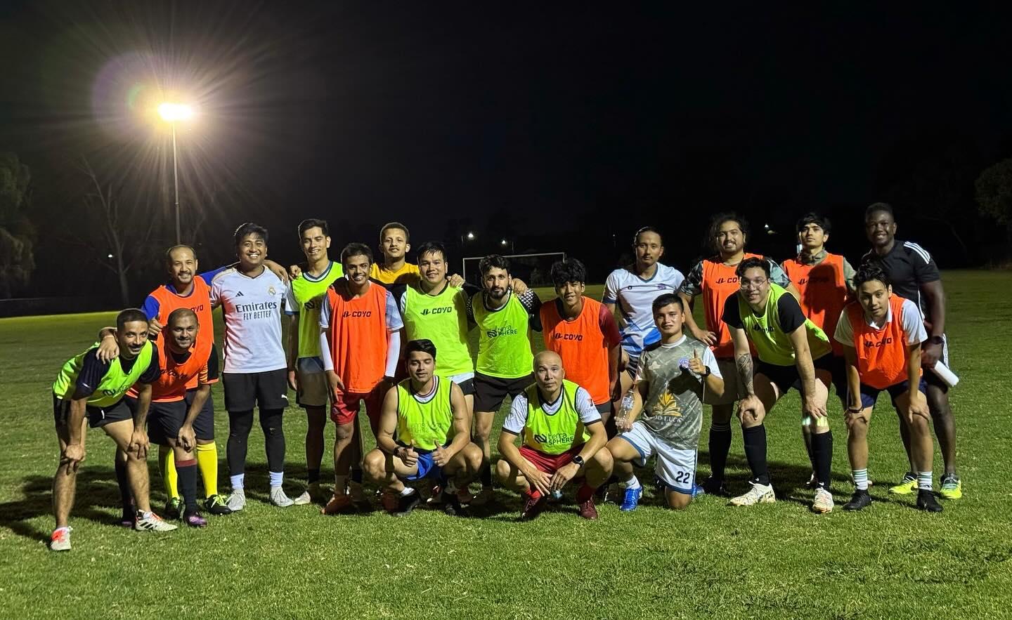 Tigers players together on the pitch under the training floodlights